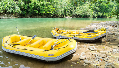 2 empty yellow rafts on shore