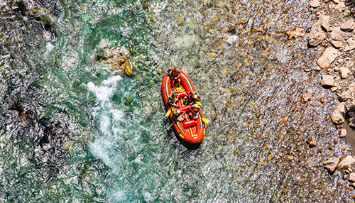 people in red raft from above